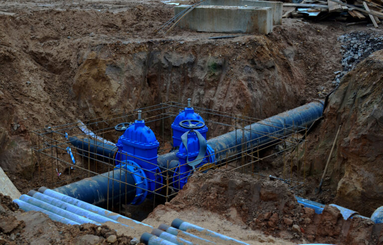Municipal workers repairing a water main pipe