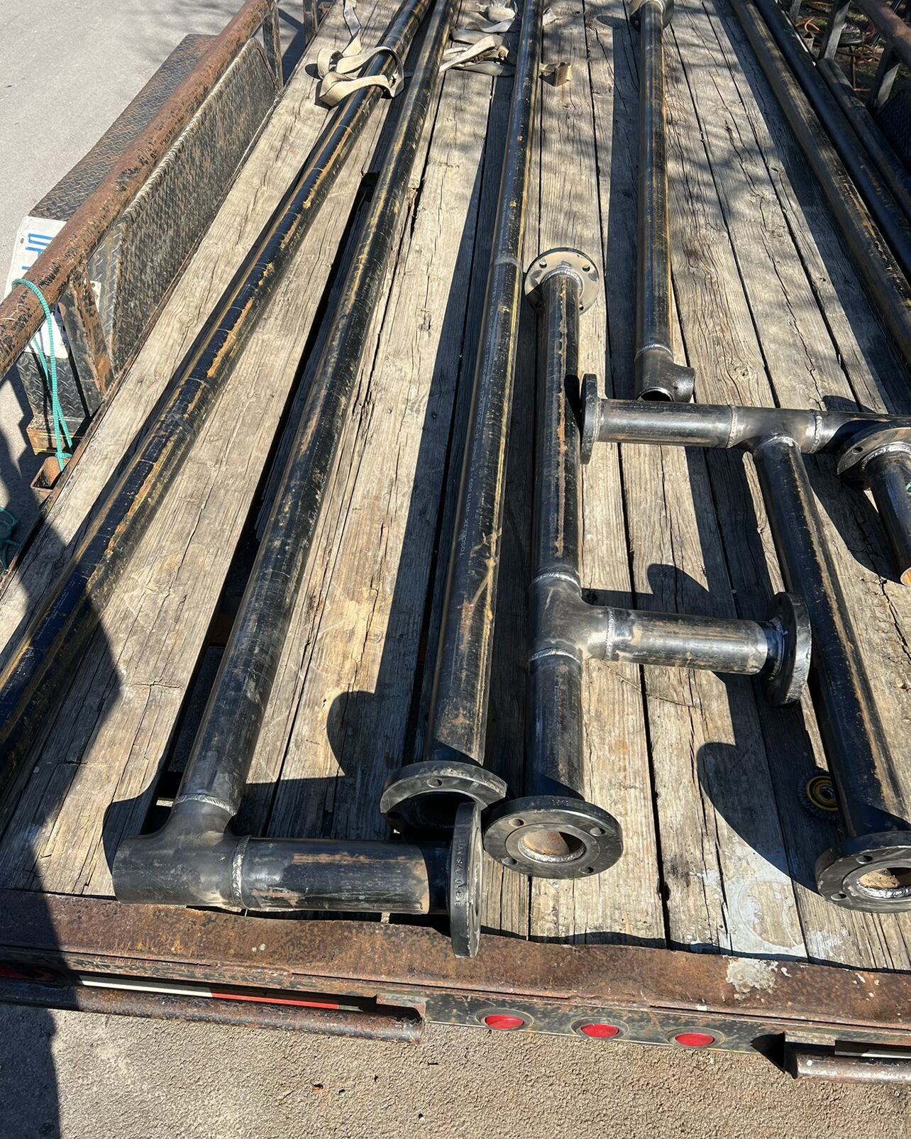 Flatbed trailer loaded with carbon steel pipe spools for new construction plant in New Caney Texas